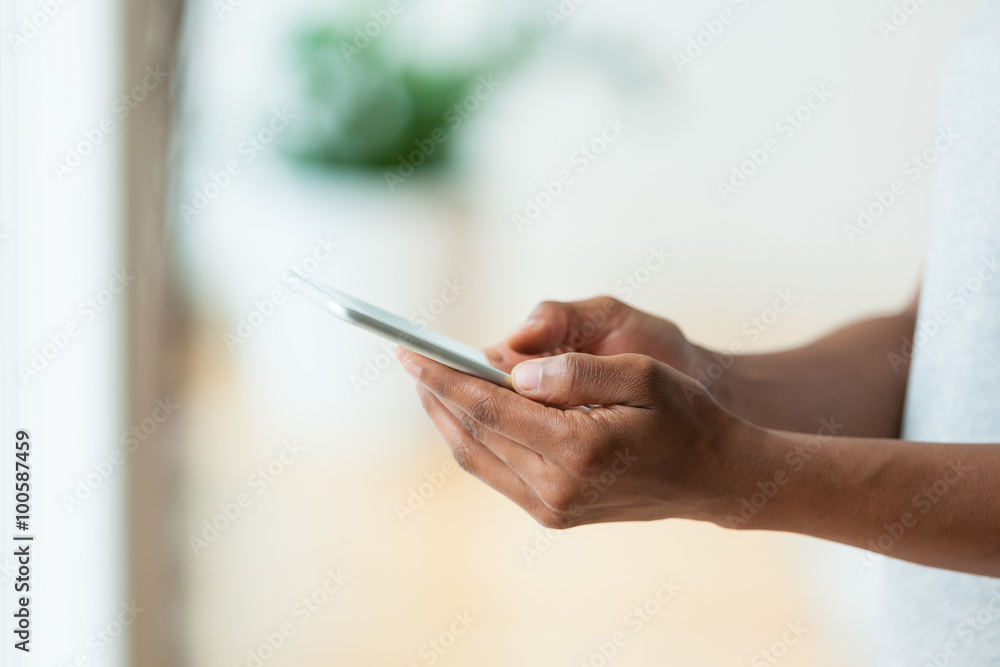African american person holding a tactile mobile smartphone - Bl African american person holding a tactile mobile smartphone - Bl
