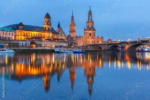 Dresden Cathedral of the Holy Trinity aka Hofkirche Kathedrale Sanctissima Trinitatis, Bruehl's Terrace aka The Balcony of Europe and Augustus Bridge with reflections in the river Elbe at night in