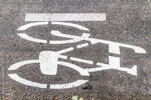 White bicycle road sign on asphalt