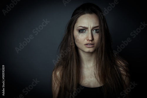Fotografie Close up portrait of a sad woman, hair disheveled.