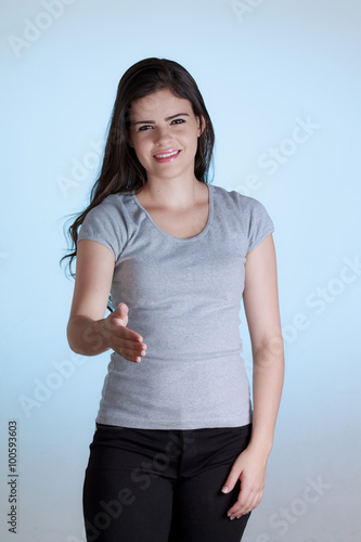 Young business woman with arm extended for a handshake