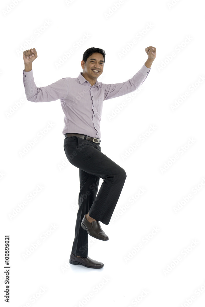 Excited Indian businessman jumping for joy. Isolated on white ba