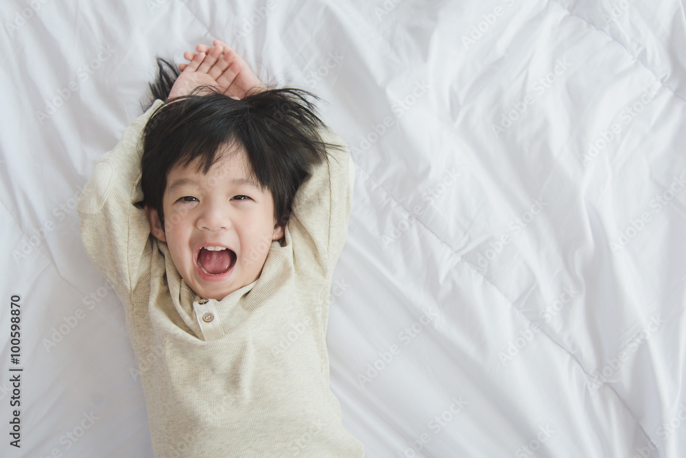 asian child lying on white bed asian child lying on white bed