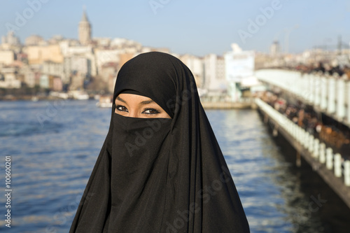 Woman dressed with black headscarf, chador on istanbul street, turkey