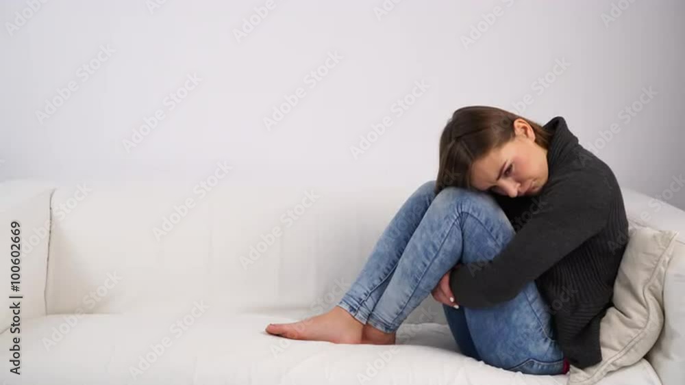 Woman sad stressed sitting on couch at home 4K Woman sad stressed sitting on couch at home 4K