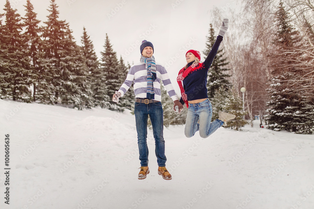 Tender couple in love jumping and having fun in the winter outdo