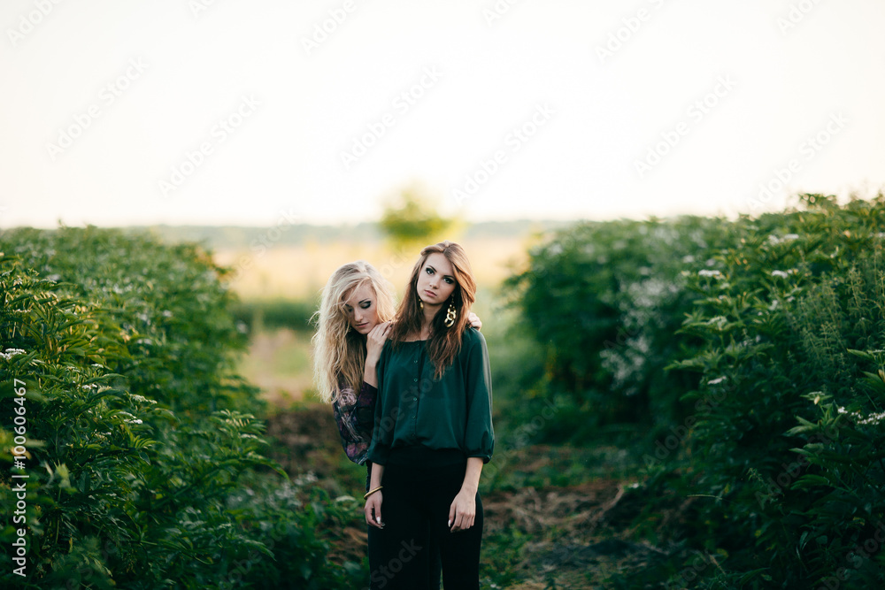 Beautiful young women posing in a flowering spring park