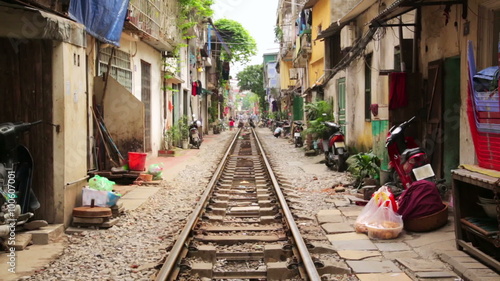 train passing through streets of hanoi slums, vietnam