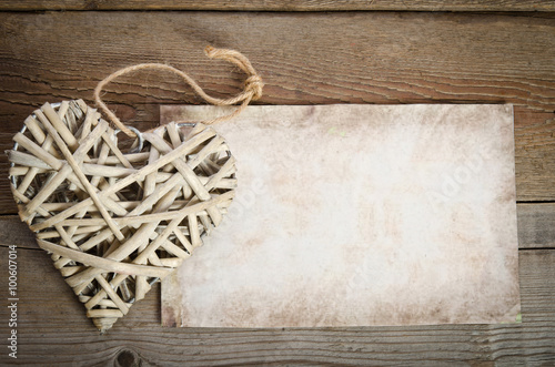 wicker heart handmade with a sheet of paper for you text lying