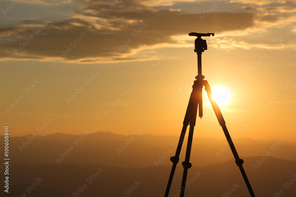 Silhouette from a recording camera on a tripod during sunrise Silhouette from a recording camera on a tripod during sunrise