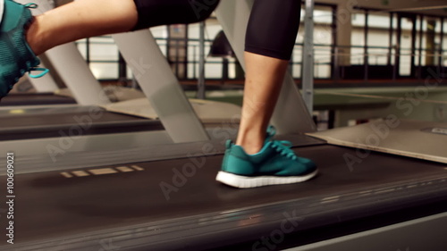 Woman running on treadmill photo