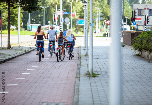 AMSTERDAM, NETHERLANDS - AUGUST 27, 2015: Group of cyclists goes around city. Amsterdam - Netherland.