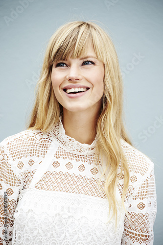 Young pretty woman in lacey top, looking away