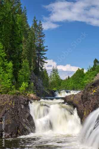 waterfalls between rocks with green trees