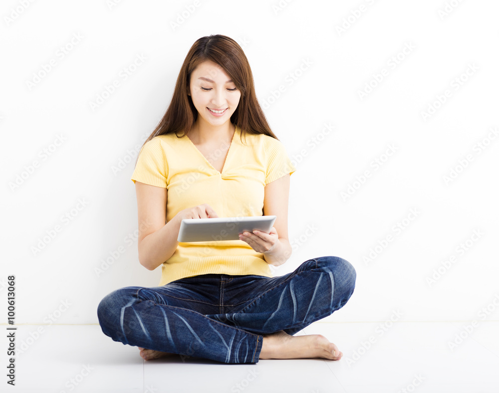 Smiling seated young woman with tablet pc Smiling seated young woman with tablet pc