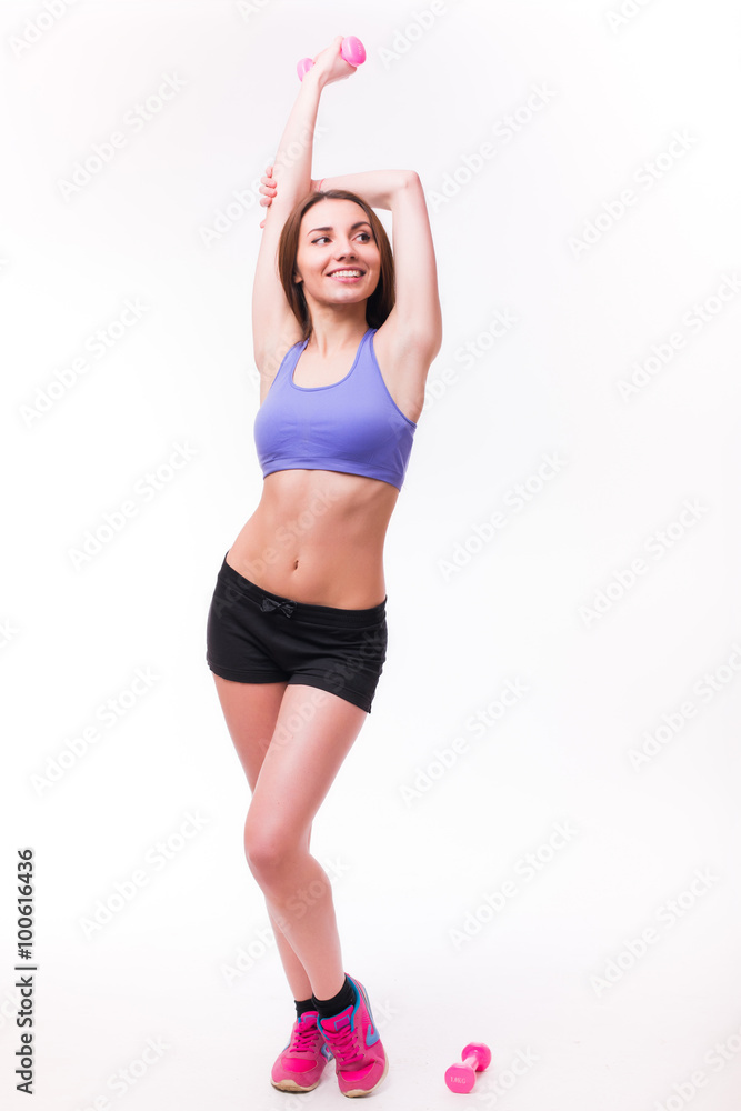 Active sportive athletic woman with dumbbells pumping up muscles biceps concept fitness sport training lifestyle Active sportive athletic woman with dumbbells pumping up muscles biceps concept fitness sport training lifestyle