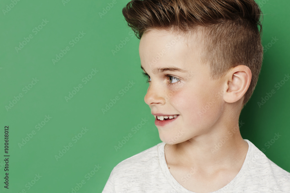 Fototapeta premium Cool young kid against green background