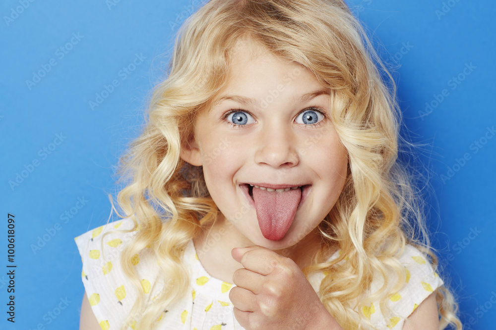 Young kid sticking out tongue, portrait 스톡 사진 Adobe Stock