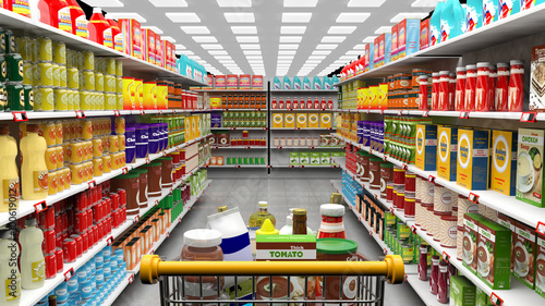Supermarket interior, shelves with various products and full trolley basket