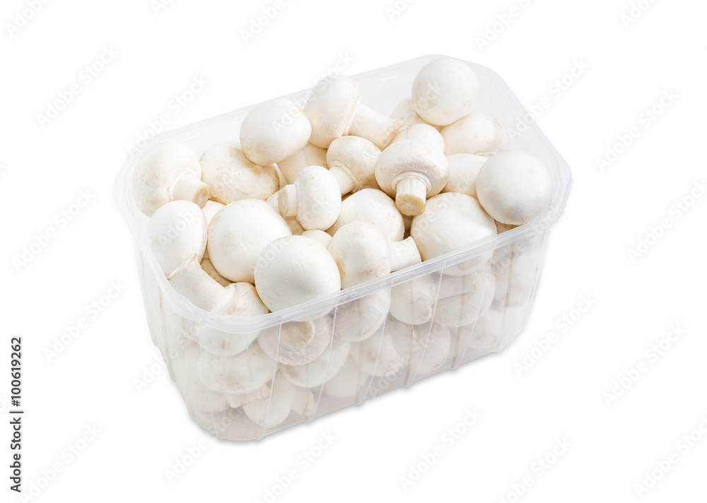 Button mushrooms in a plastic tray on a light background Button mushrooms in a plastic tray on a light background