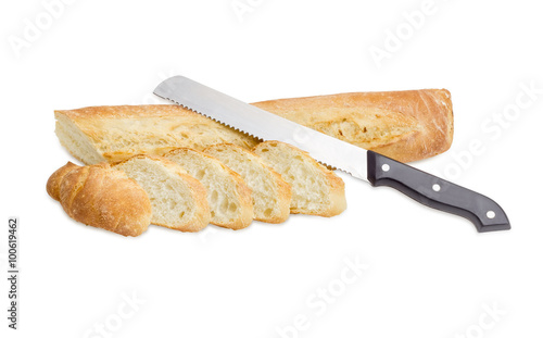 Baguette and bread knife on a light background