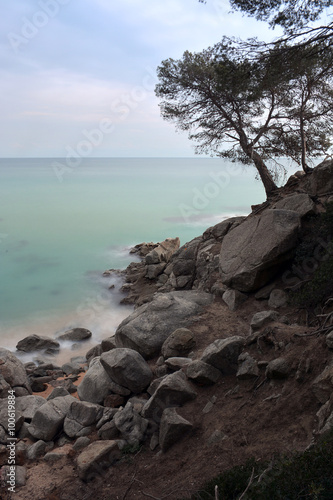 waves crashing into the rocks of the sea © expressiovisual