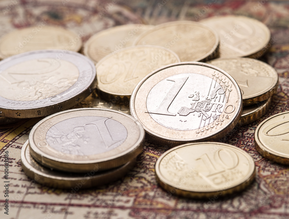 Euro coins over the old world map. Euro coins over the old world map.