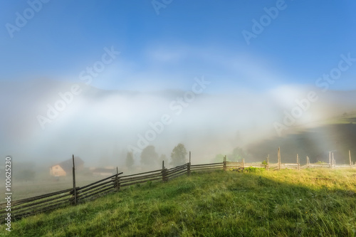Carpathian Mountains. Overcast with a white rainbow, fence with cobwebs