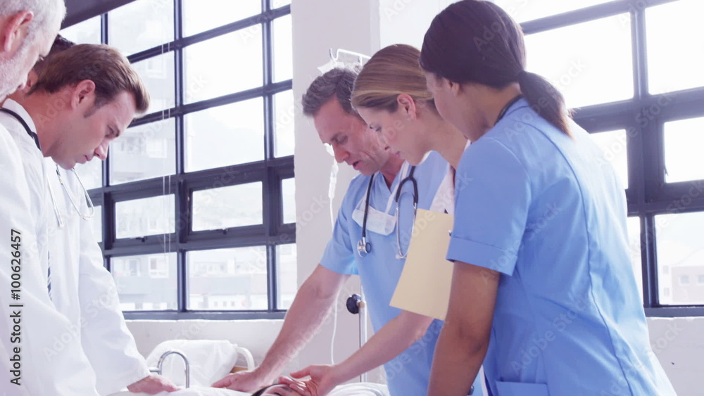 Doctors around a female patient Doctors around a female patient