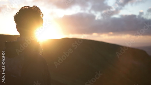 Slow motion of young caucasian man staring into the sunset on Azores Island