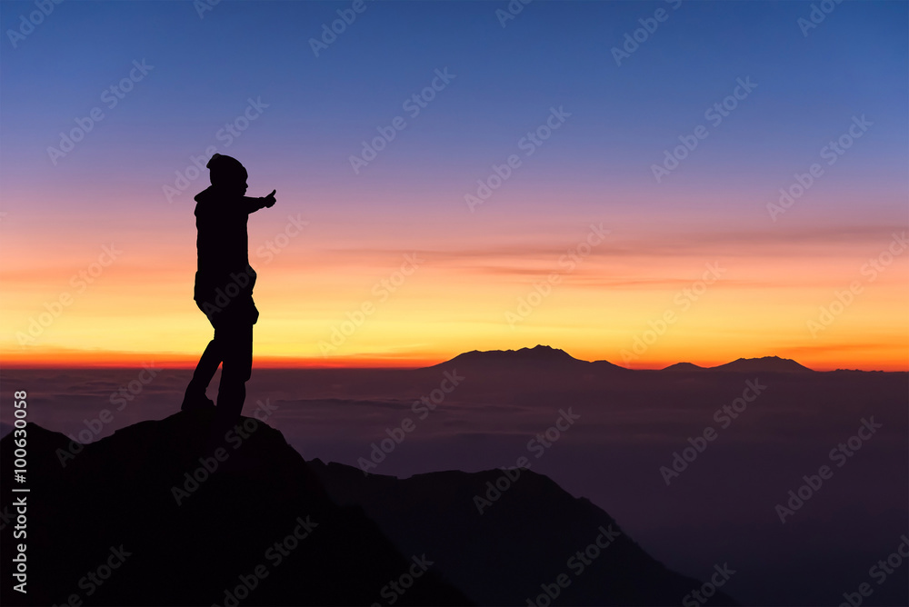 Fototapeta premium silhouette of man standing and thumbs up on the top of mountain