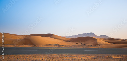 desert  sand dunes and the road in the evening