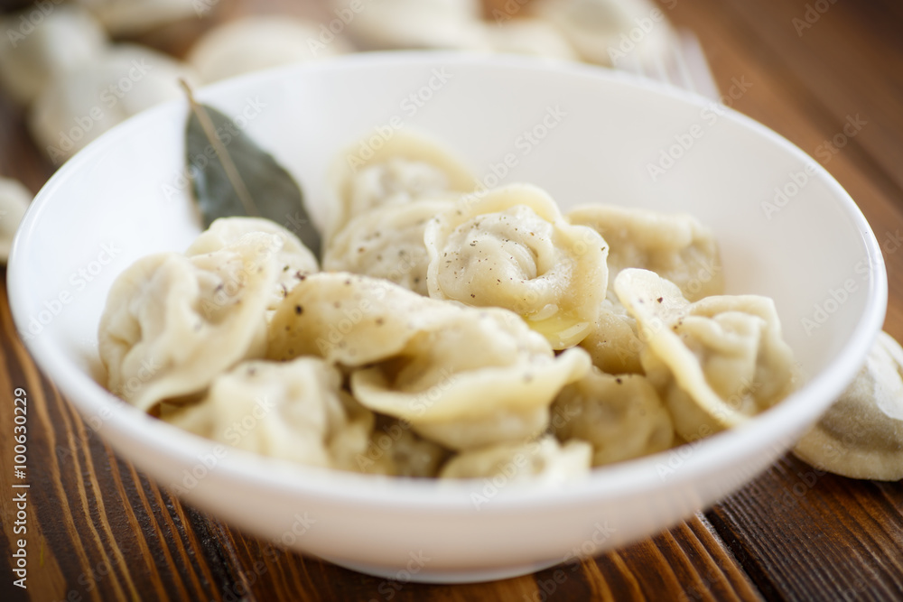boiled dumplings with meat in a white plate boiled dumplings with meat in a white plate