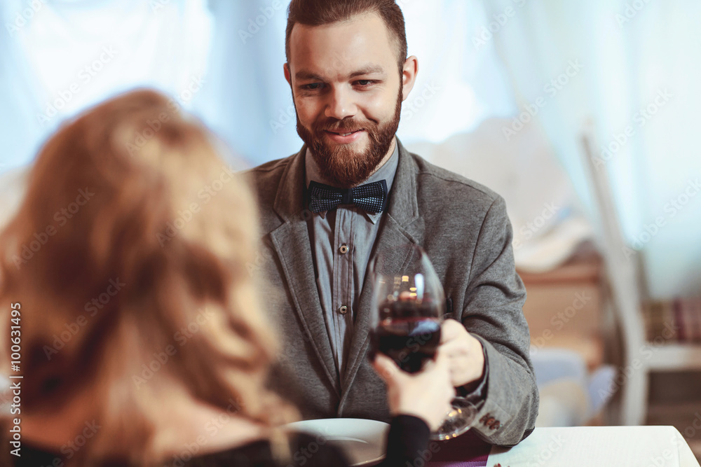 Beautiful young couple with glasses of red wine in luxury restaurant Beautiful young couple with glasses of red wine in luxury restaurant