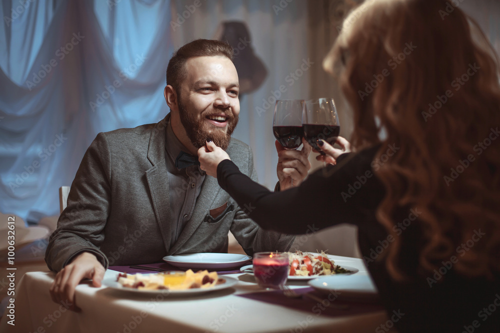 Beautiful young couple with glasses of red wine in luxury restaurant Beautiful young couple with glasses of red wine in luxury restaurant