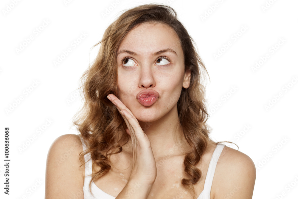 Portrait of thoughtful young woman with pursed lips Portrait of thoughtful young woman with pursed lips