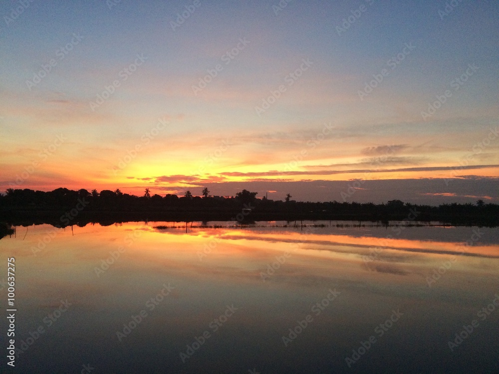 sunrise and reflection on water with silhouete 