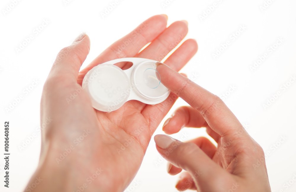 Contact lens on finger with case Contact lens on finger with case