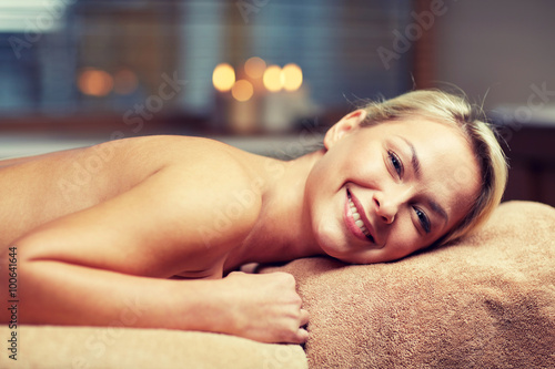 young woman lying on massage table in spa