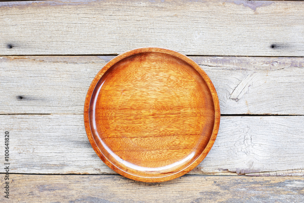 brown wooden plate on wooden table brown wooden plate on wooden table
