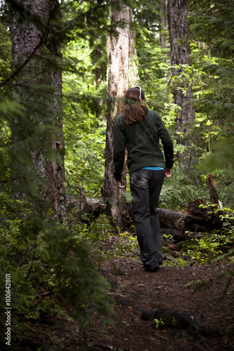 Woman Hiking Through The Woodland Wilderness
