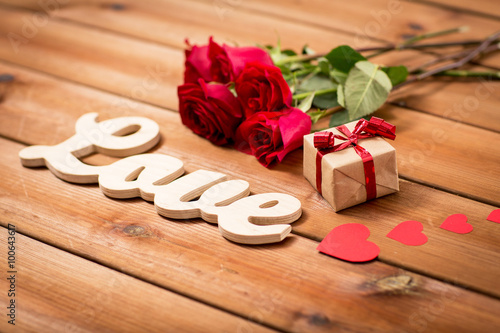 close up of gift, word love, red roses and hearts