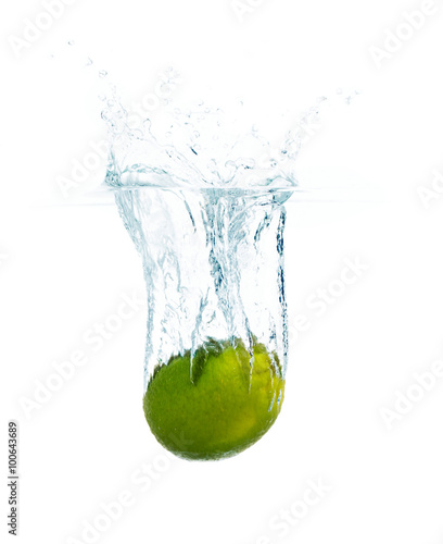 lime falling or dipping in water with splash