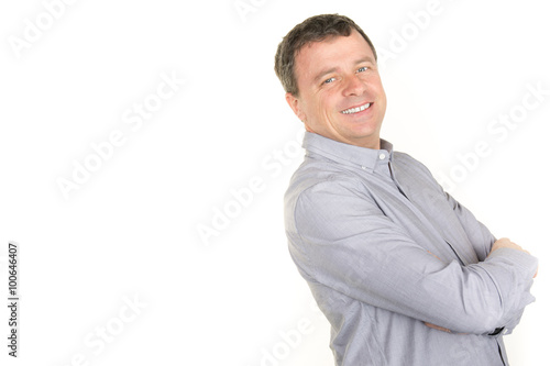 Happy smiling  man leaning against white wall with copy space © OceanProd