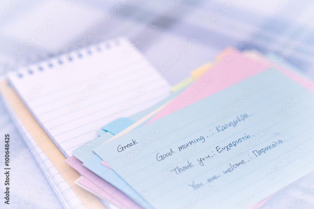 Greek; Learning New Language Writing Greetings on the Notebook Greek; Learning New Language Writing Greetings on the Notebook