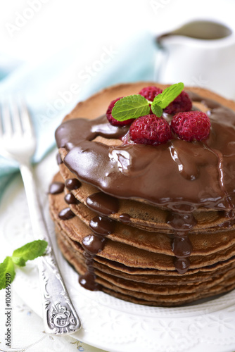Chocolate pancakes with raspberry and chocolate sauce