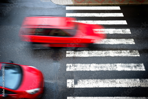 two red cars on the pedestrian crossing