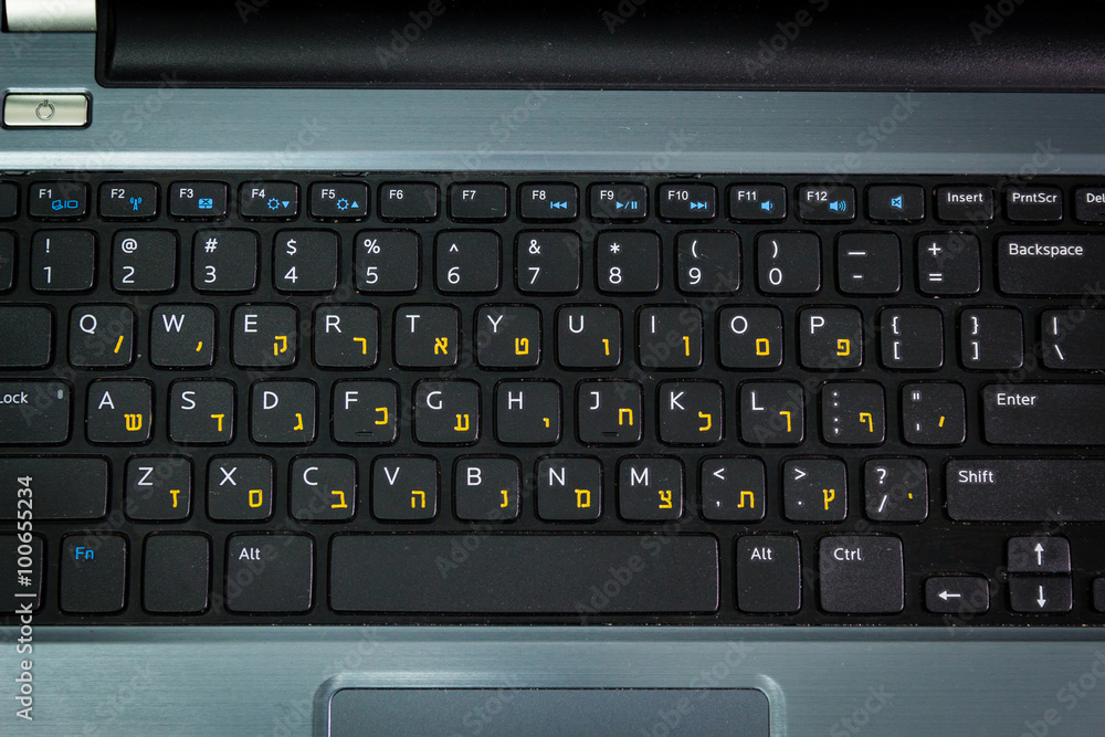 Keyboard with letters in Hebrew and English - Laptop keyboard - Top View - Dark atmosphere Keyboard with letters in Hebrew and English - Laptop keyboard - Top View - Dark atmosphere