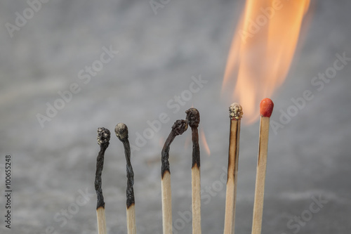 Row of burning matches photo