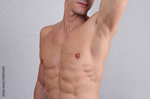 Male Waxing. Muscular male torso, chest and armpit hair removal close up.